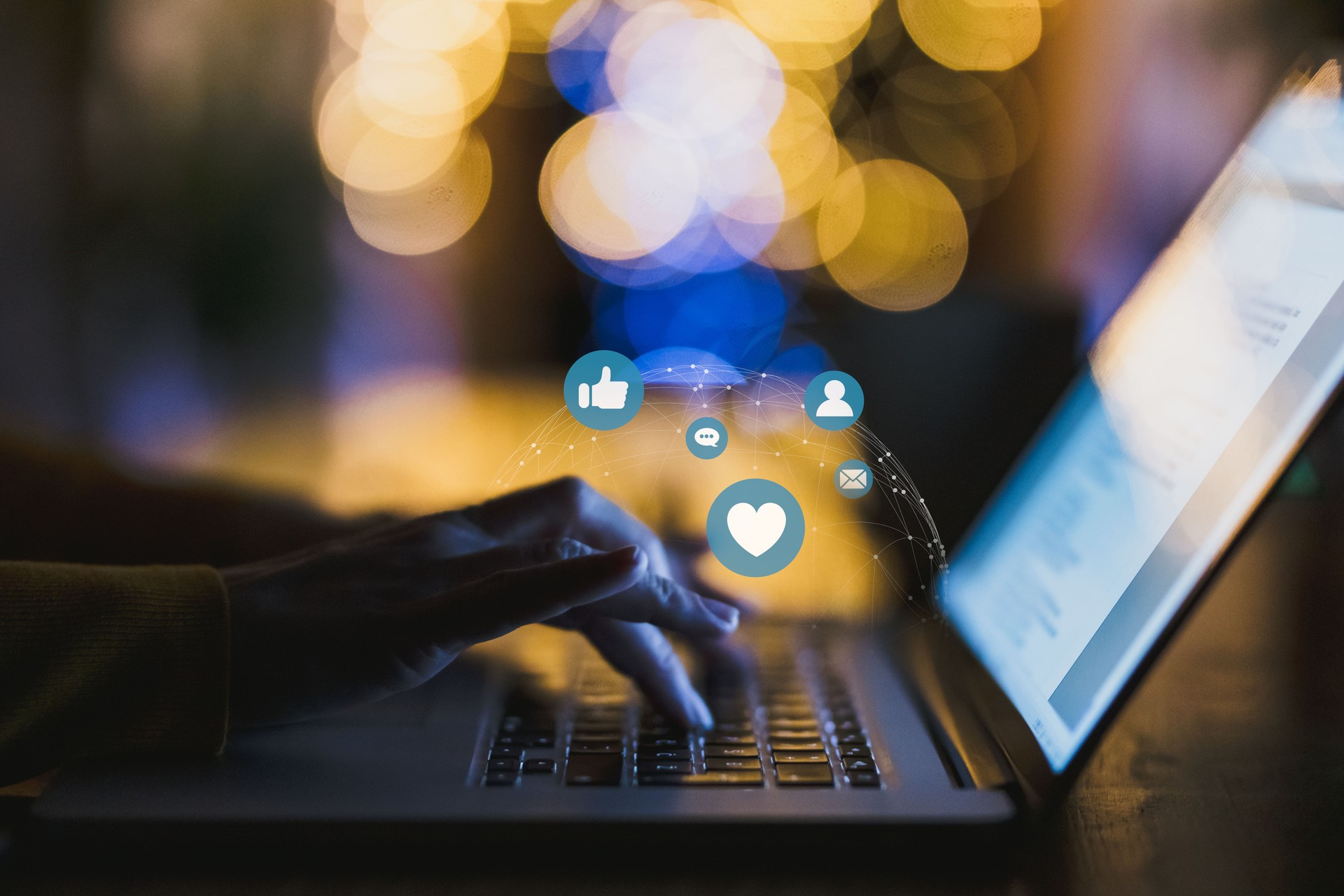 Woman typing on laptop with icon social media