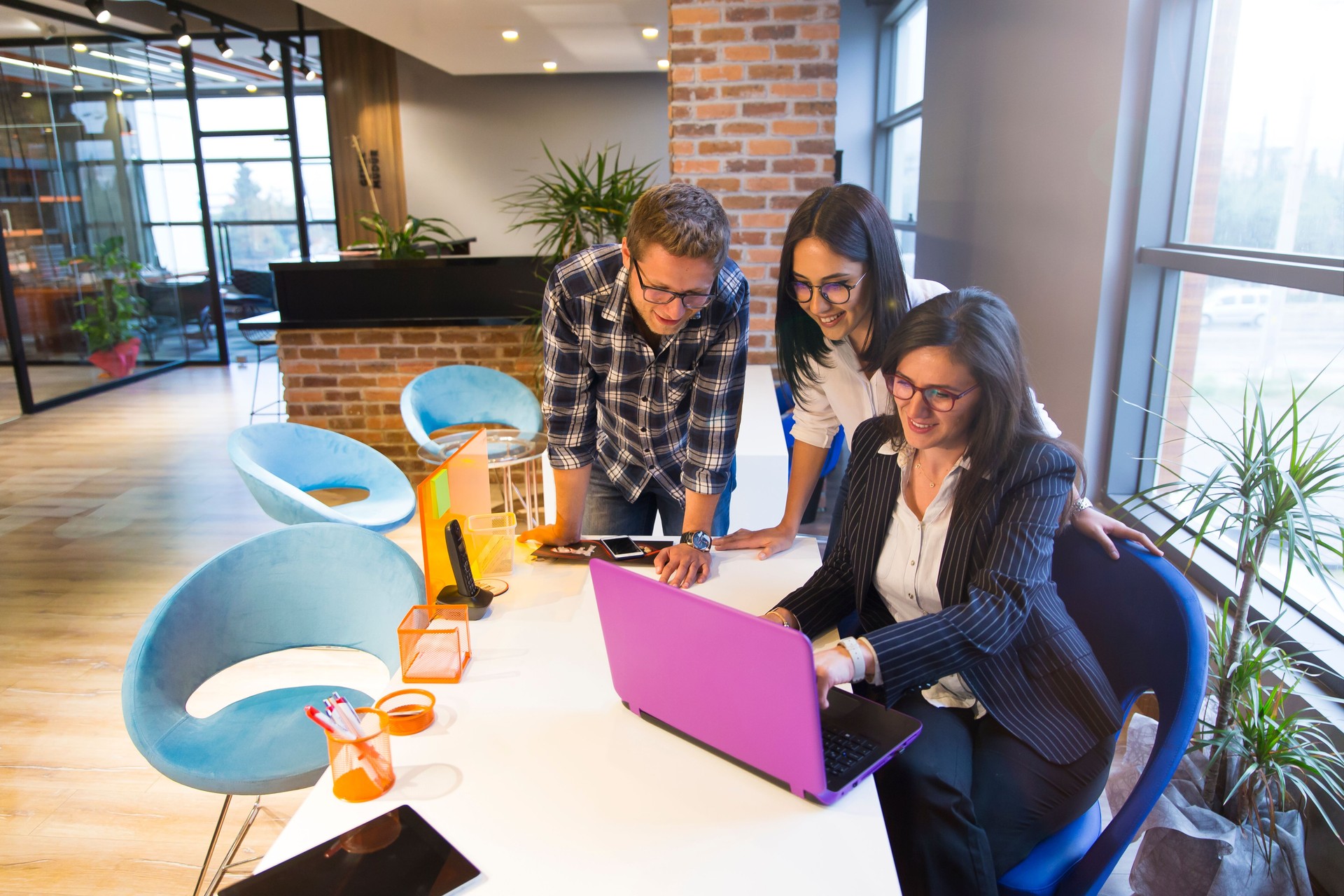 Young couple getting advice in office from beautiful business woman